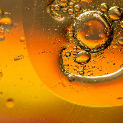 Oil and water mixing and forming bubbles and droplets