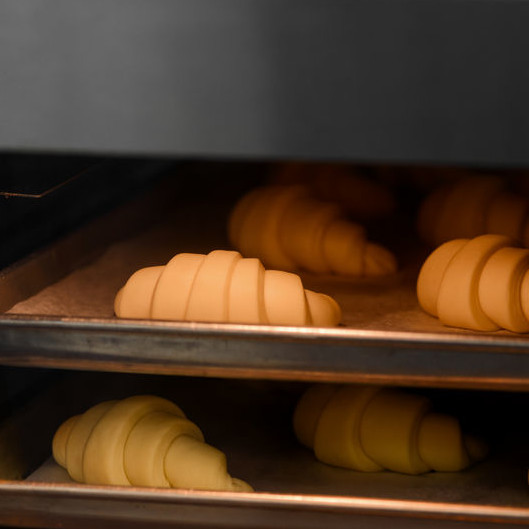 A convection oven uses fans to circulate hot air around the product placed on racks in the baking chamber, good for products like pastry.