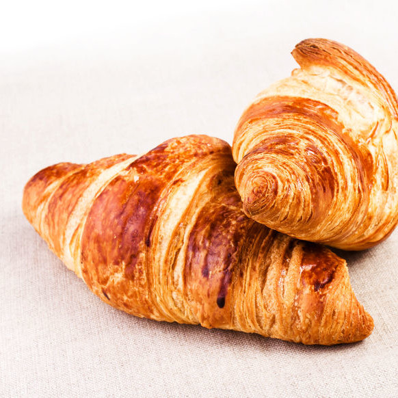 A croissant is a laminated, yeast-leavened bakery product with a flaky, crispy texture.
