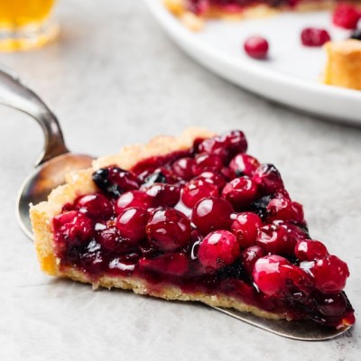 A piece of pie with jellied fresh cranberries.